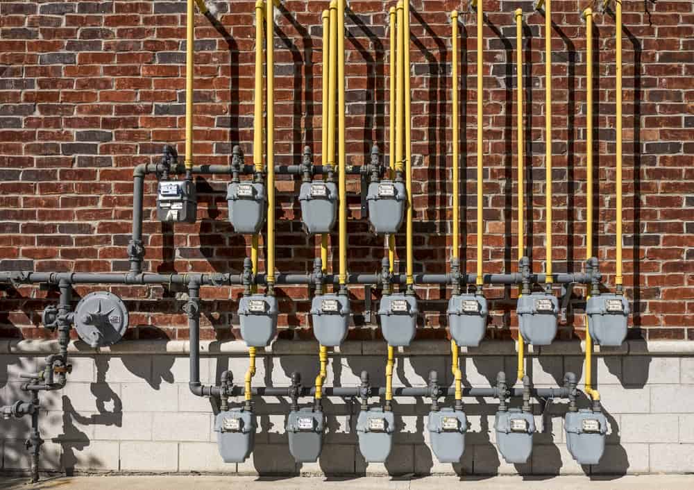 closeup of a gas meters outside of building.